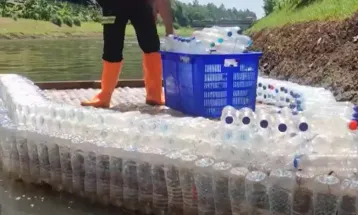 Reuse and Recycle: Waste Officers Use Mineral Water Bottles to Build Boats